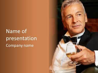 A Man In A Tuxedo Holding A Glass Of Wine PowerPoint Template