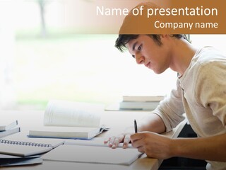 A Man Sitting At A Desk Writing On A Piece Of Paper PowerPoint Template