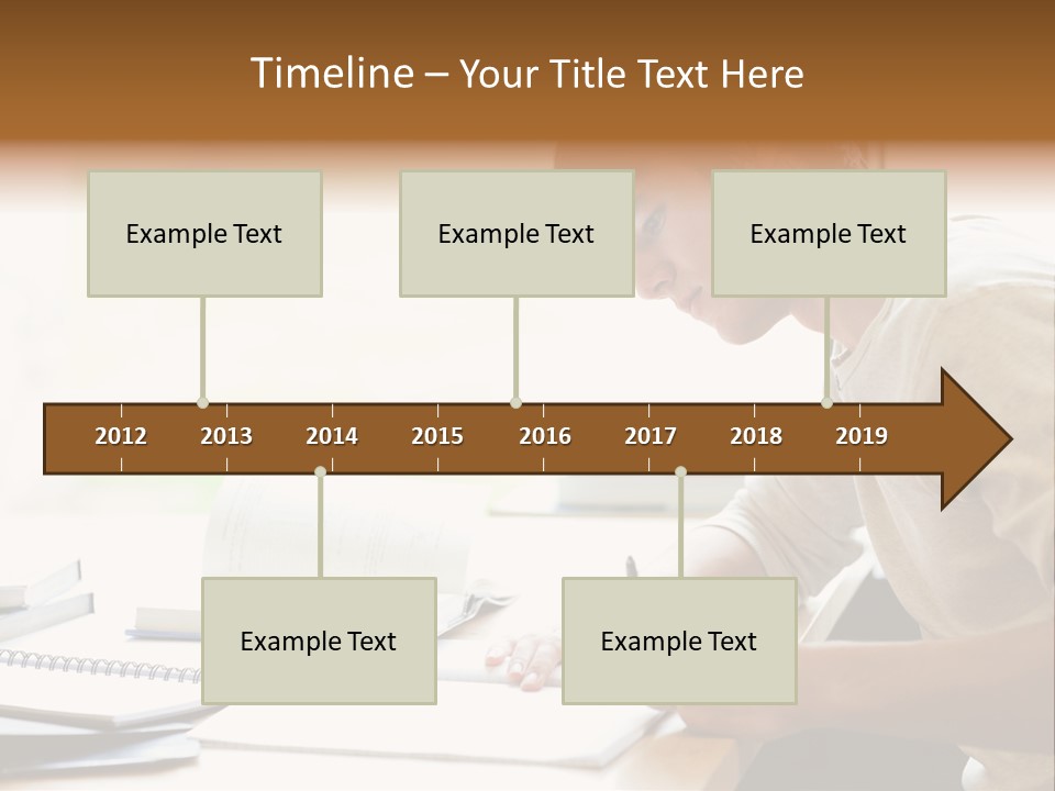 A Man Sitting At A Desk Writing On A Piece Of Paper PowerPoint Template