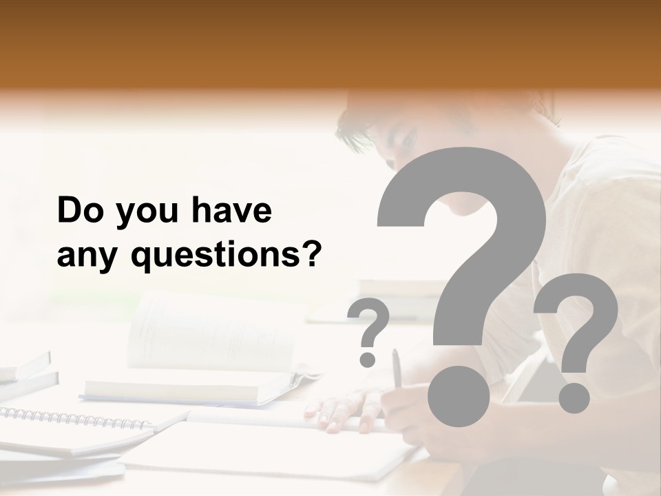 A Man Sitting At A Desk Writing On A Piece Of Paper PowerPoint Template