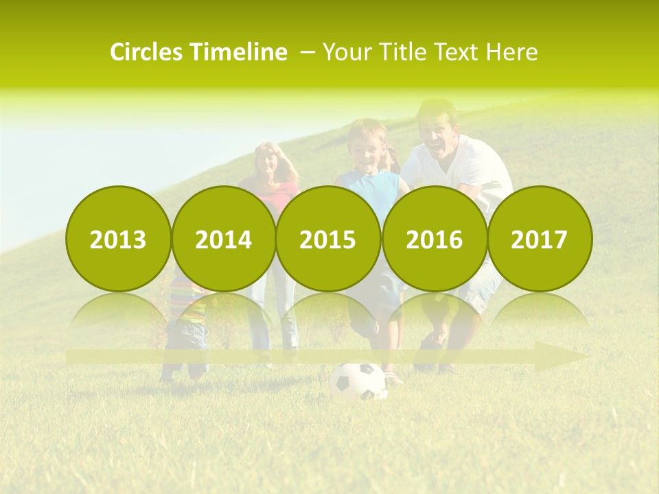 A Family Playing With A Soccer Ball In A Field PowerPoint Template