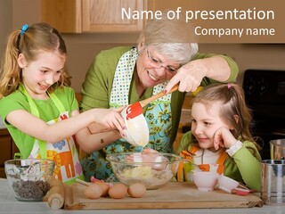 A Woman And Two Young Girls Mixing Eggs In A Bowl PowerPoint Template