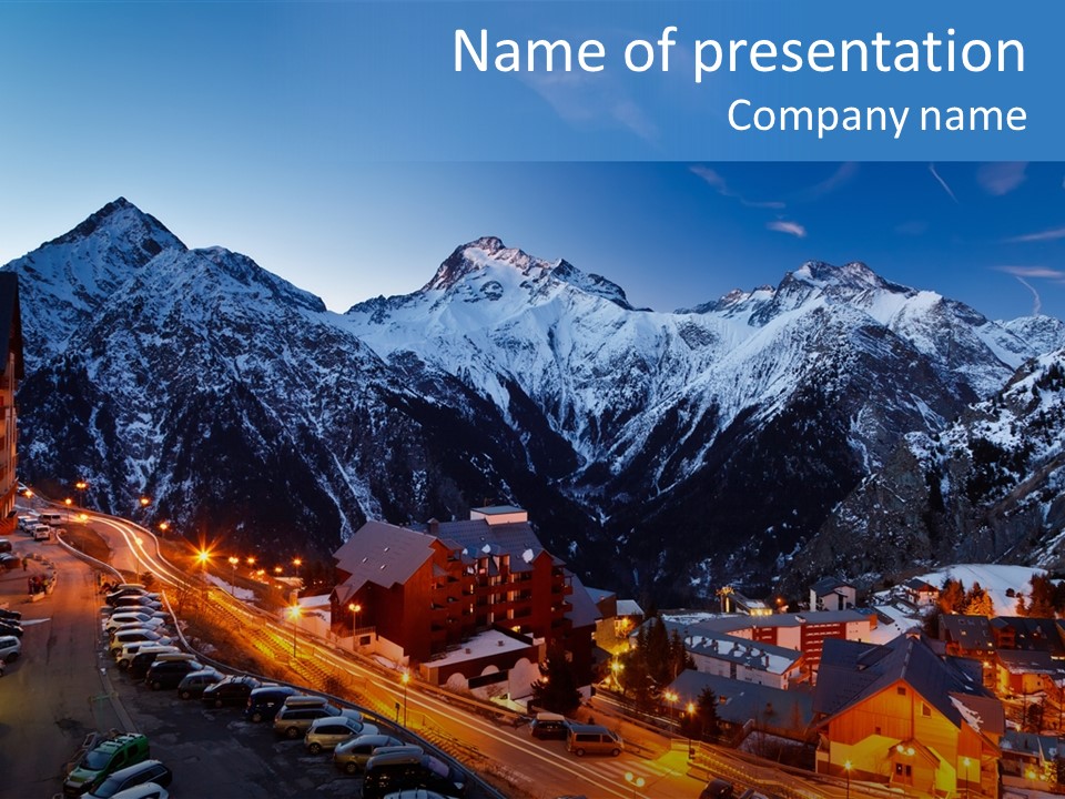 A Snowy Mountain Range With A Town In The Foreground PowerPoint Template