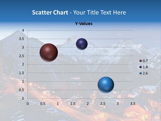 A Snowy Mountain Range With A Town In The Foreground PowerPoint Template