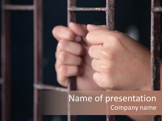 A Person's Hand Holding The Bars Of A Jail Cell PowerPoint Template