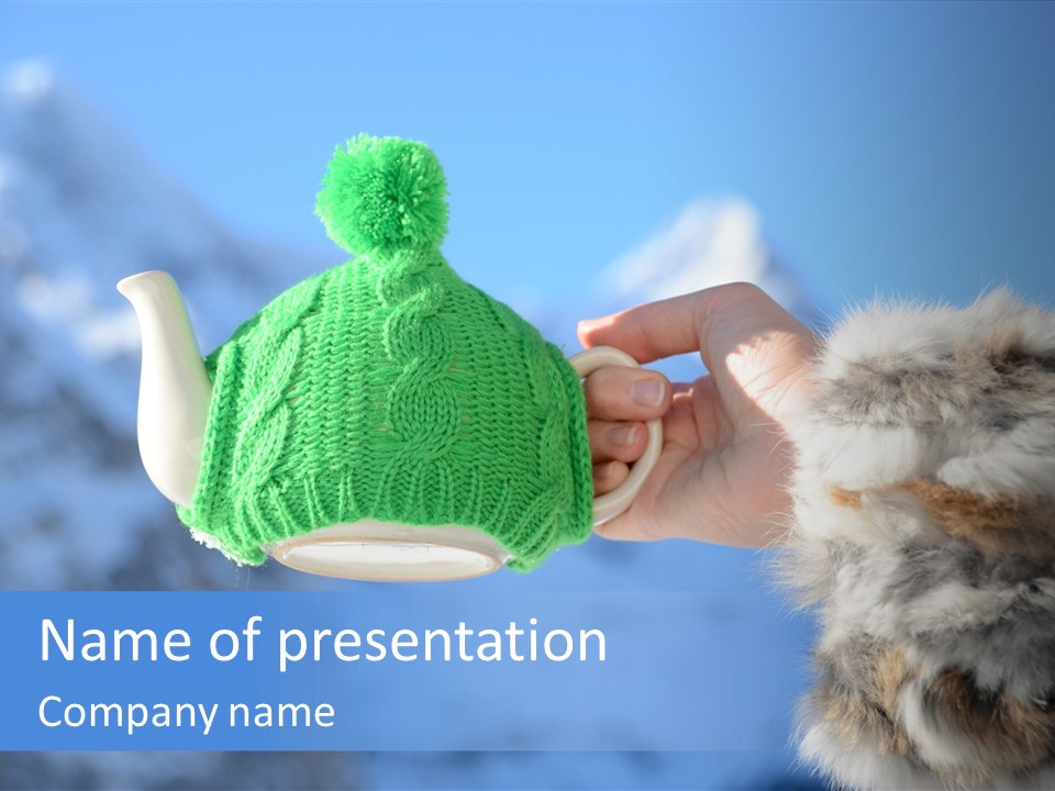 A Person Holding A Teapot With A Green Knitted Hat On It PowerPoint Template