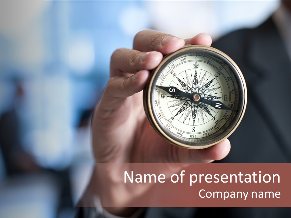 A Man Holding A Compass In His Hand PowerPoint Template