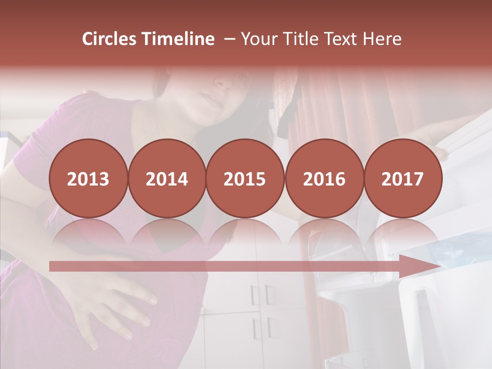 A Woman Standing Next To A Refrigerator In A Kitchen PowerPoint Template