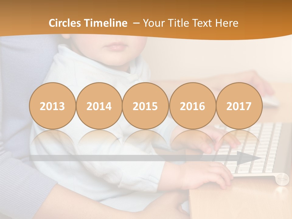 A Woman Holding A Baby Using A Laptop Computer PowerPoint Template