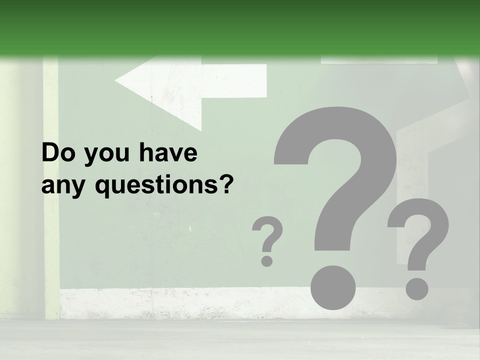 A Man Walking Down A Street Next To A Green Wall PowerPoint Template