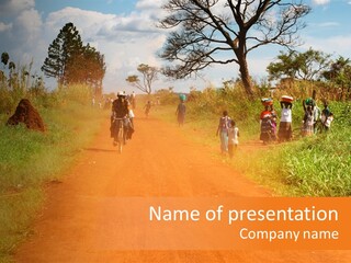 A Group Of People Riding Bikes Down A Dirt Road PowerPoint Template