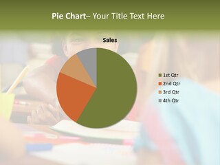 A Young Girl Smiles As She Sits At A Desk PowerPoint Template