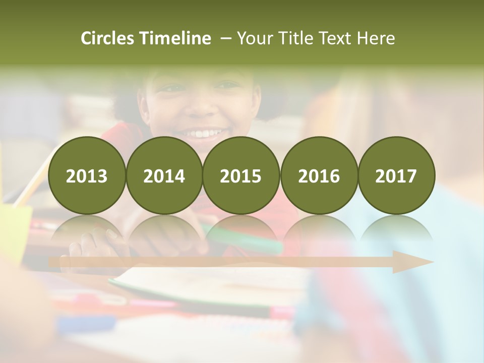 A Young Girl Smiles As She Sits At A Desk PowerPoint Template