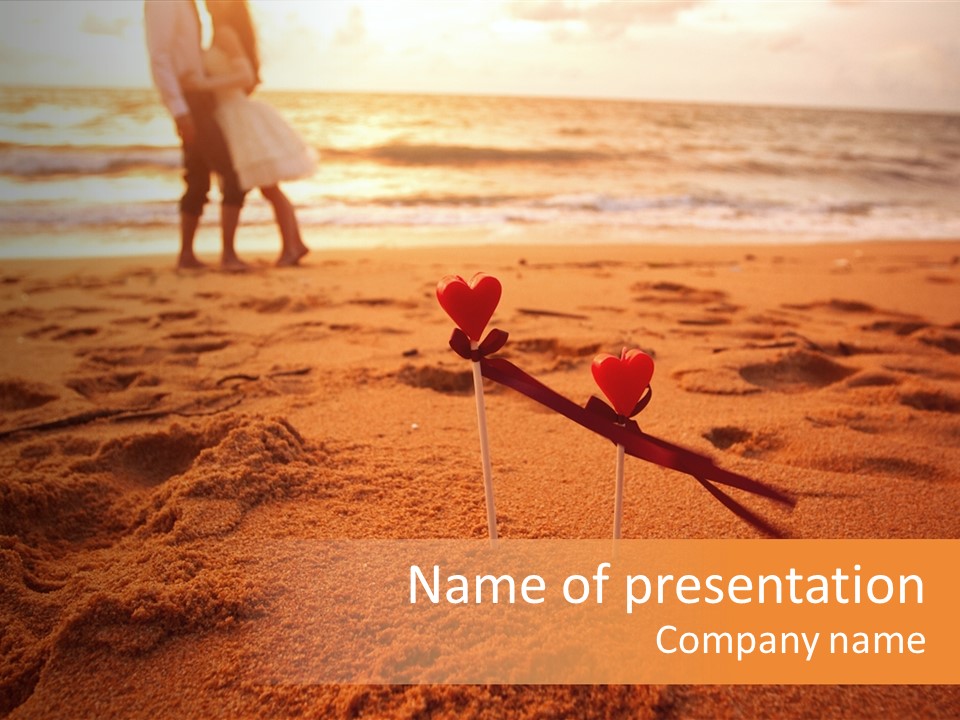 A Couple Standing On A Beach Holding Hands PowerPoint Template