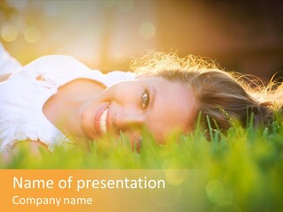 A Beautiful Young Woman Laying In The Grass PowerPoint Template