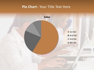 A Group Of People Sitting At A Table With Computers PowerPoint Template