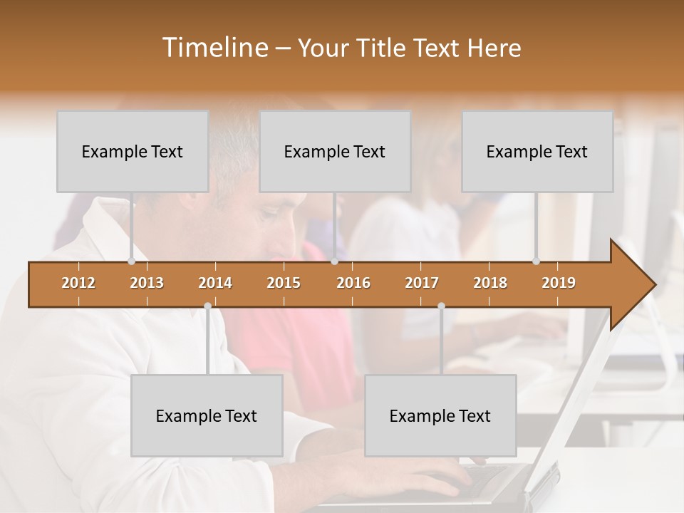 A Group Of People Sitting At A Table With Computers PowerPoint Template
