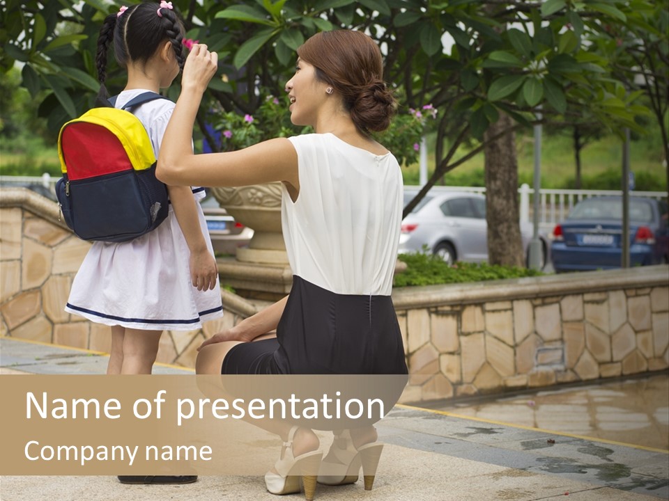 A Woman Kneeling Down Next To A Little Girl PowerPoint Template