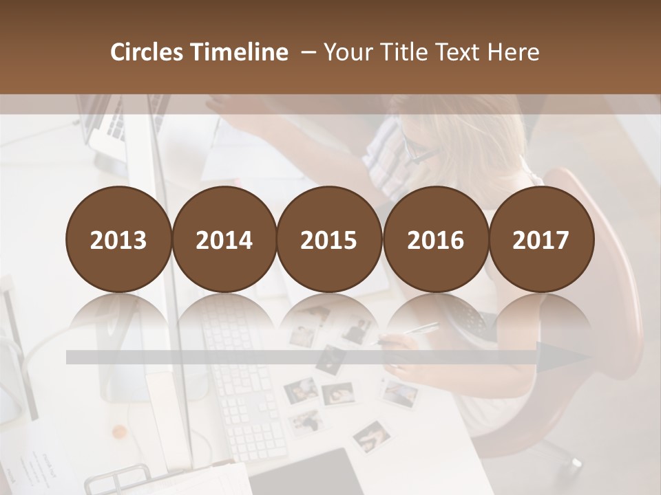 A Man And A Woman Sitting At A Desk Working On A Laptop PowerPoint Template