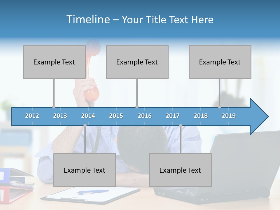A Man Sitting At A Desk With A Laptop And Telephone PowerPoint Template