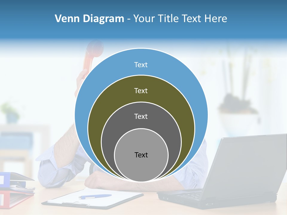 A Man Sitting At A Desk With A Laptop And Telephone PowerPoint Template