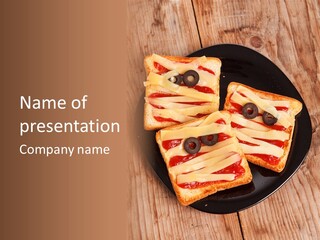 A Black Plate Topped With Slices Of Pizza Covered In Cheese And Olives PowerPoint Template