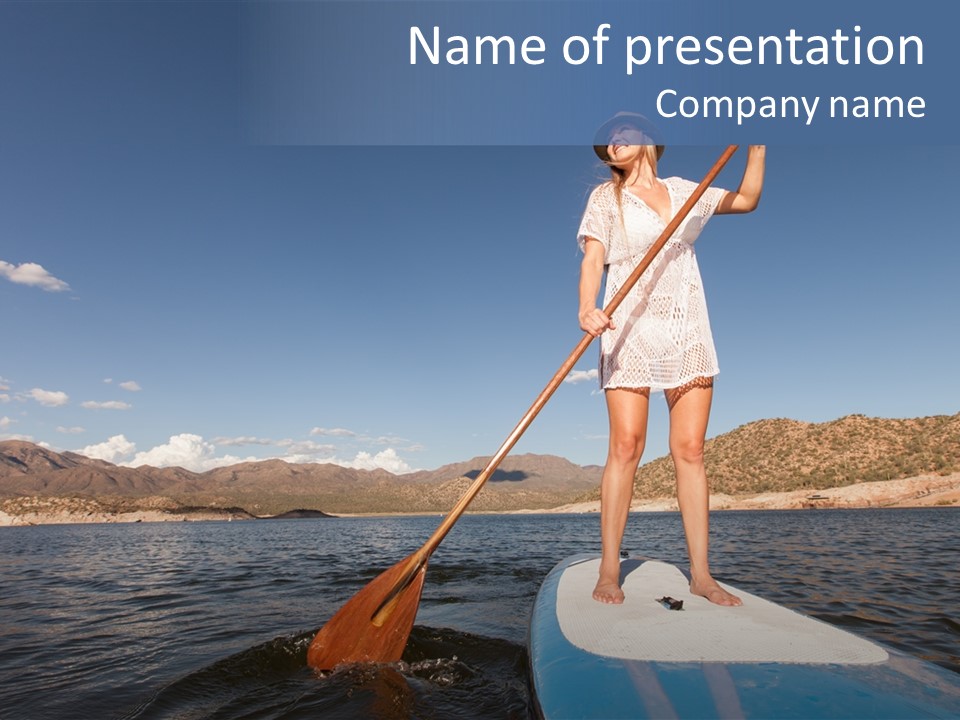 A Woman Standing On A Paddle Board In The Water PowerPoint Template