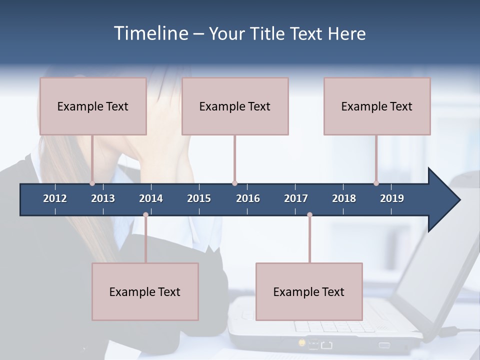 A Woman Sitting At A Desk Covering Her Face With Her Hands PowerPoint Template