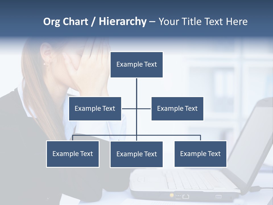 A Woman Sitting At A Desk Covering Her Face With Her Hands PowerPoint Template