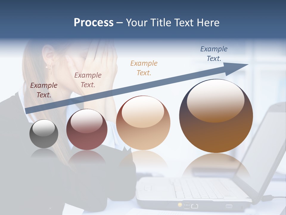 A Woman Sitting At A Desk Covering Her Face With Her Hands PowerPoint Template