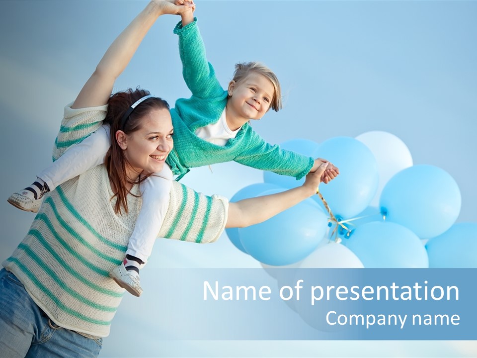 A Woman Holding A Child In Her Arms With Balloons In The Background PowerPoint Template