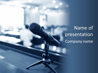 A Microphone On A Table With A Blurry Background PowerPoint Template