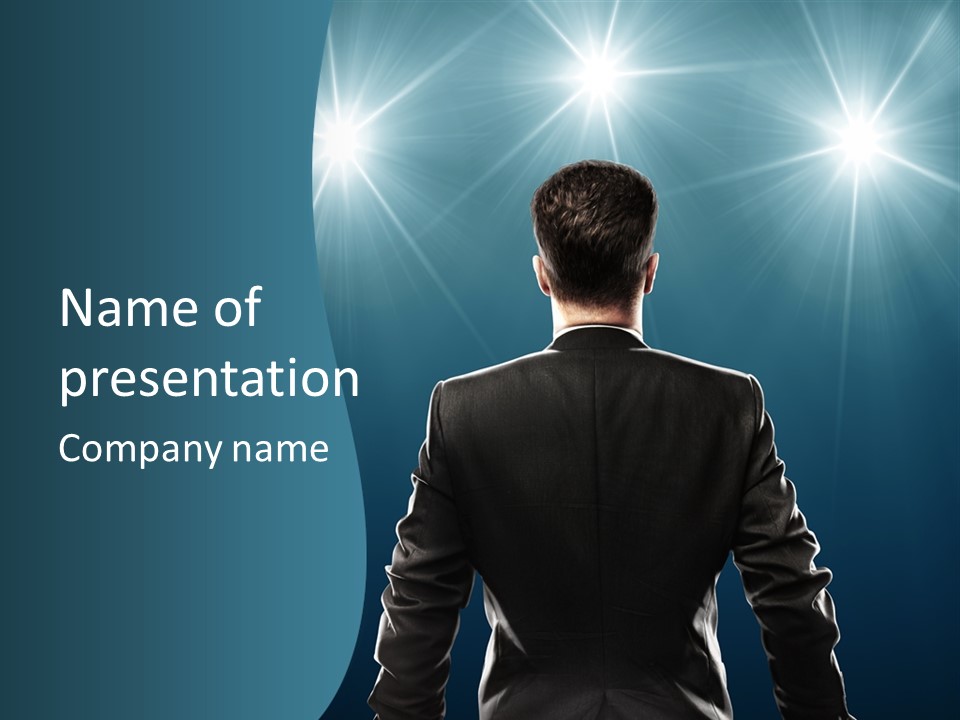 A Man In A Suit Standing In Front Of A Spotlight PowerPoint Template