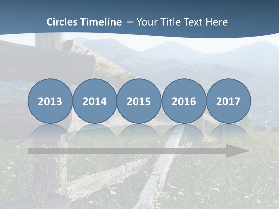 A Wooden Fence In A Grassy Field With Mountains In The Background PowerPoint Template