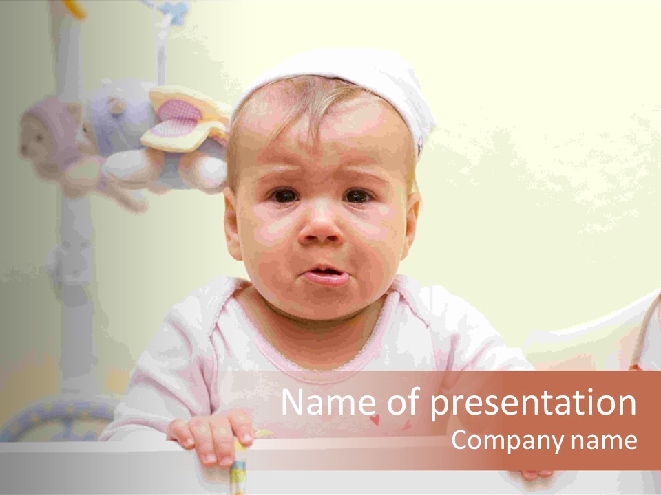 A Baby Is Holding A Toothbrush In His Hand PowerPoint Template