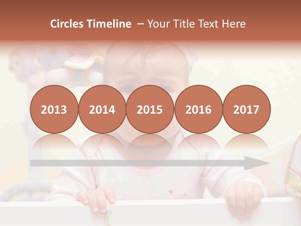 A Baby Is Holding A Toothbrush In His Hand PowerPoint Template