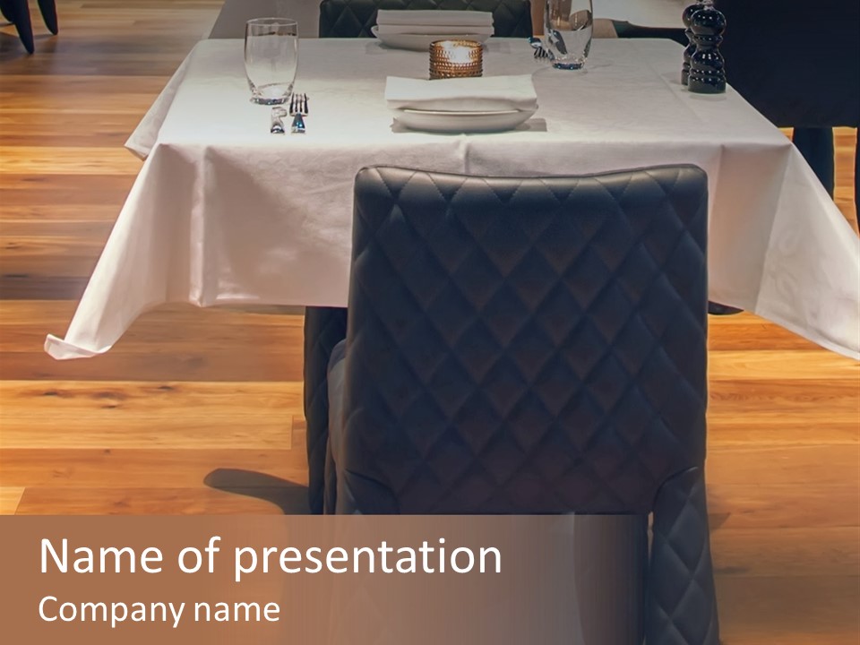 A Table With A White Table Cloth And Black Chairs PowerPoint Template