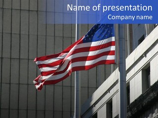 An American Flag Flying In Front Of A Building PowerPoint Template