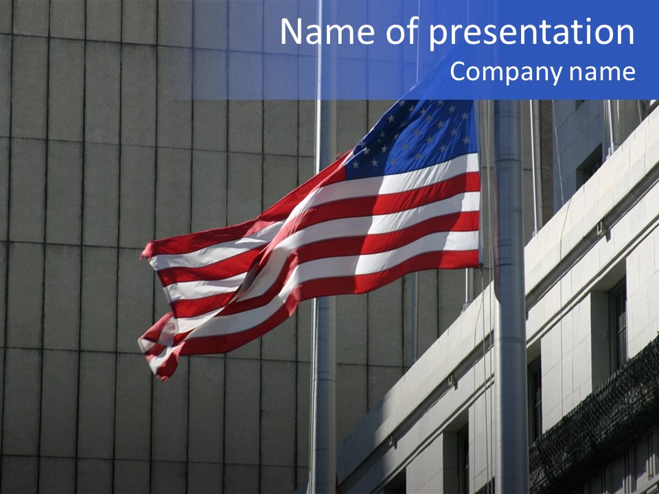 An American Flag Flying In Front Of A Building PowerPoint Template
