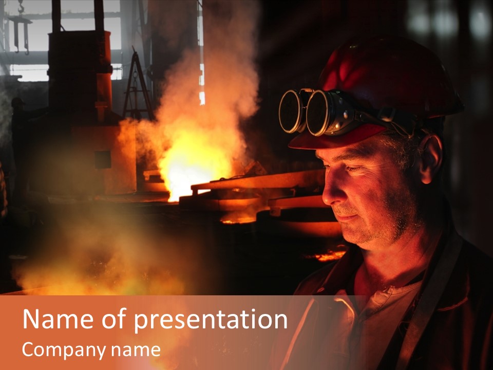 A Man Wearing A Hard Hat And Goggles In A Factory PowerPoint Template