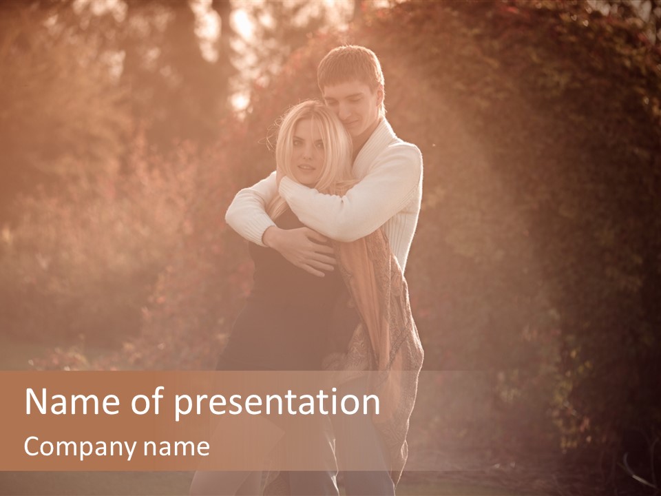 A Man And A Woman Hugging In A Park PowerPoint Template