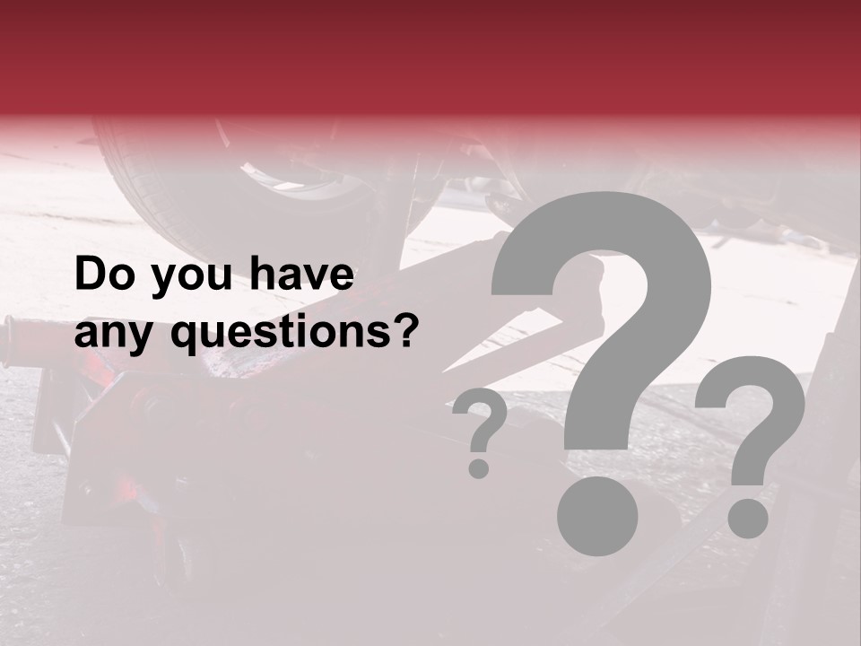 A Close Up Of A Red Jack Under A Car PowerPoint Template