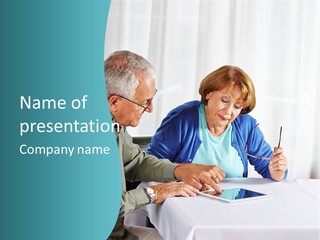 A Man And Woman Sitting At A Table Writing On A Piece Of Paper PowerPoint Template