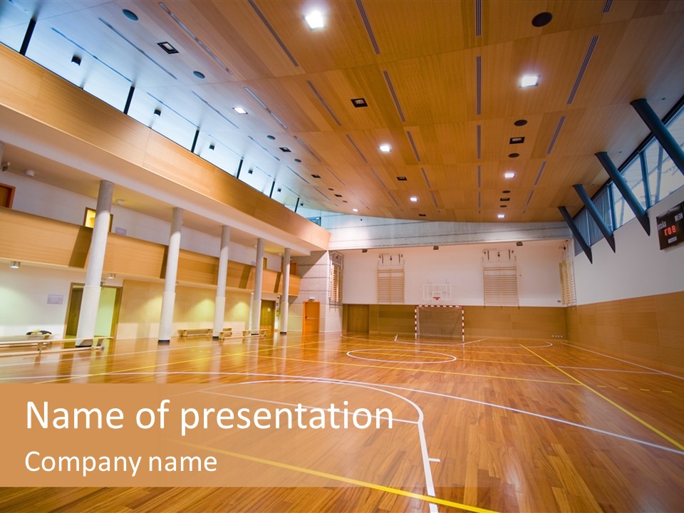 A Large Gymnasium With A Basketball Court And Wooden Floors PowerPoint Template