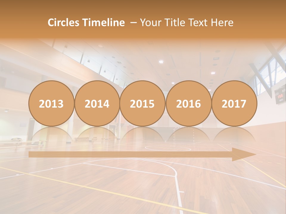 A Large Gymnasium With A Basketball Court And Wooden Floors PowerPoint Template