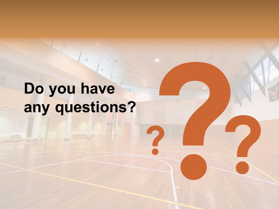 A Large Gymnasium With A Basketball Court And Wooden Floors PowerPoint Template