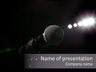 A Microphone In Front Of A Stage With Spotlights PowerPoint Template