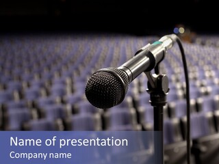 A Microphone In Front Of A Row Of Seats PowerPoint Template