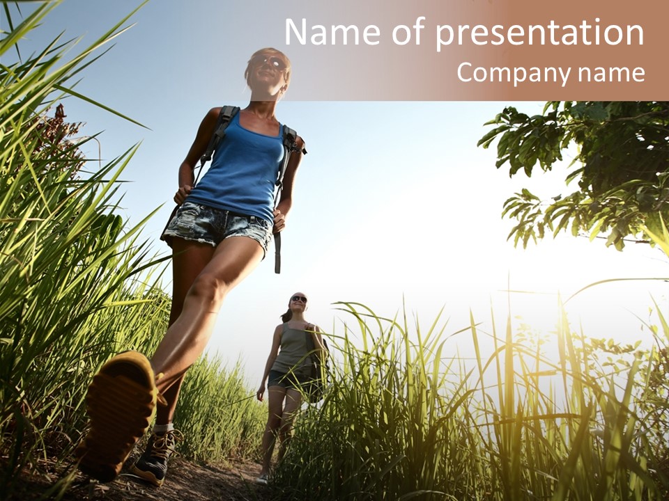 A Couple Of People That Are Walking In The Grass PowerPoint Template