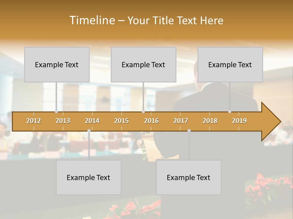 A Man Standing At A Podium In Front Of A Crowd Of People PowerPoint Template
